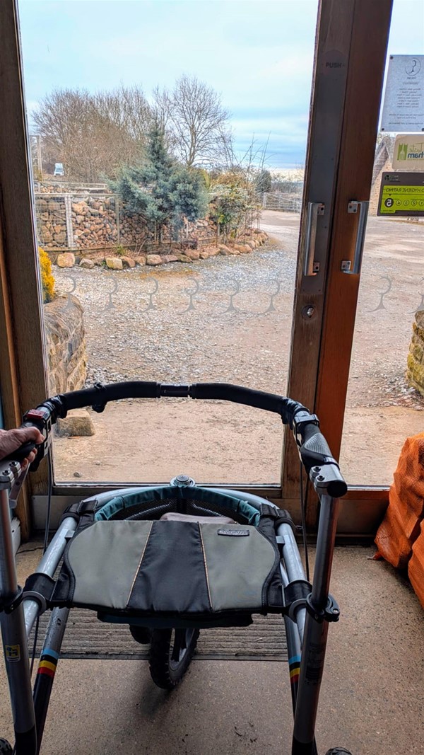 This shows my walking aid which is wide, fits through the entrance.