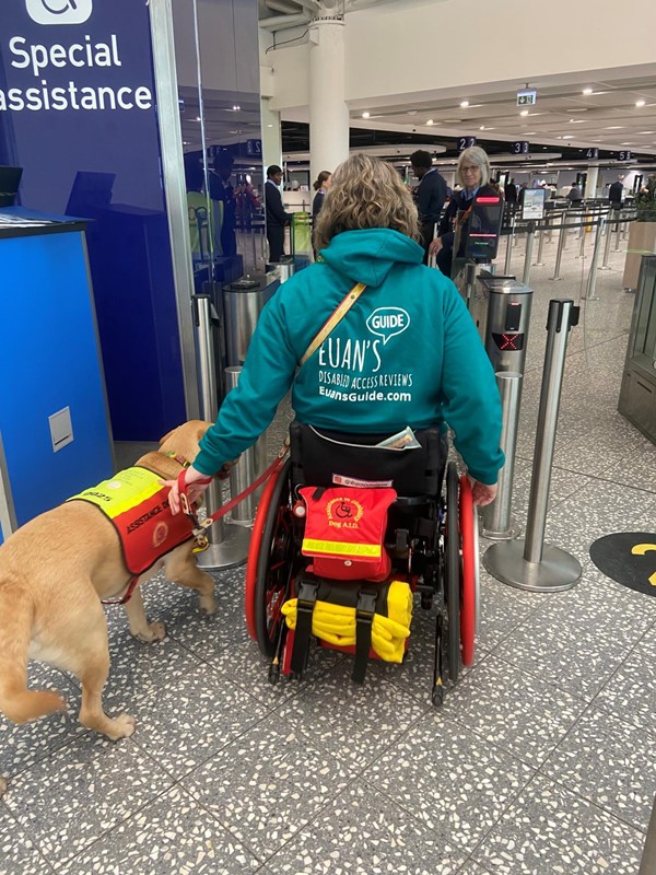 Image of a wheelchair user and assistance dog at Bristol Airport