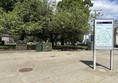 Image of park from outside with information board