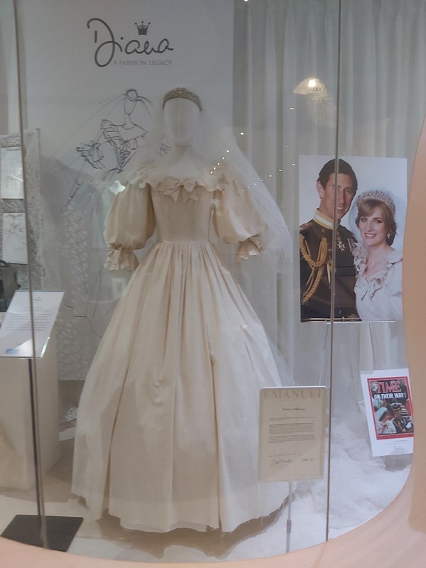 Image of a wedding dress in a glass case