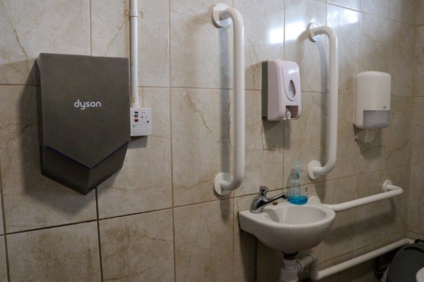 Sink with grab rails and hand dryer