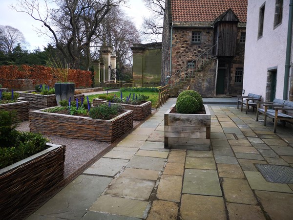 Paving section of the garden with bench seating on the right