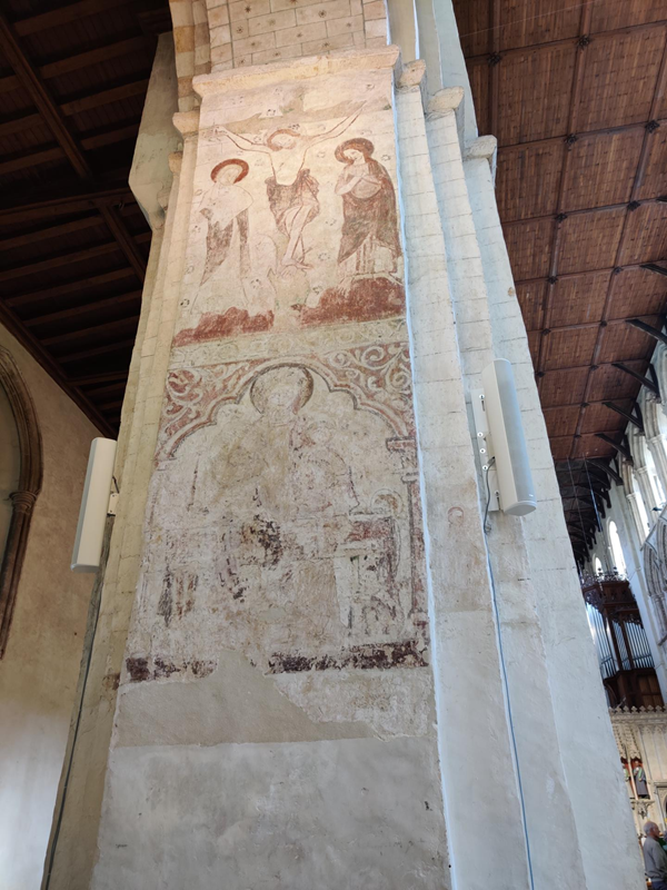 Two of the remarkable medieval wall paintings, one is of the crucifixion with two people watching, and the other painting seems to be of the virgin Mary and baby Jesus.