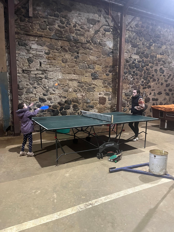 Table tennis in the play barn. There's also badminton, basketball, table football and darts, as well as children's ride on toys and small playhouse. Plenty room to run and scoot around, inside and out.