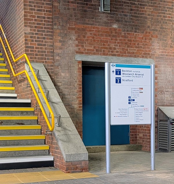 Image of stairs and signage to platforms 1 and 2 from street level