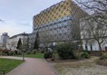 Image of a walkway in the park with the library in the background