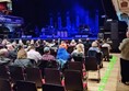 Picture of an audience facing a stage