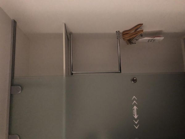 The wardrobe has sliding doors which are quite stiff to open, but has lowered hanging space.