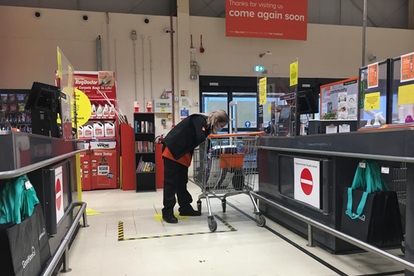 Image of the till area of the B&Q store showing staff member scanning my items.