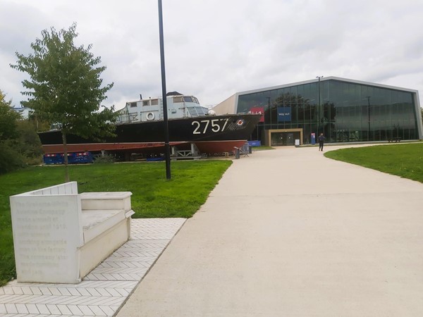 Picture of a boat outside of a glass exhibition space