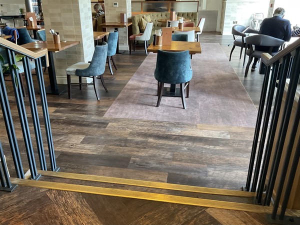 Image of stairs going down to a bar area