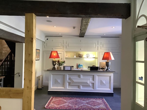 with a good reputation for its plain simple food, bought from local producers. Back up the steps again, and opposite the coffee shop, you will find the reception desk, plain and simple, but maned from morn till lat