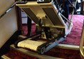 Stair climber being used. The figure in the chair is me and the staff pictured have given consent to use all attached photos