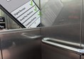image of handrail and mirror inside the lift