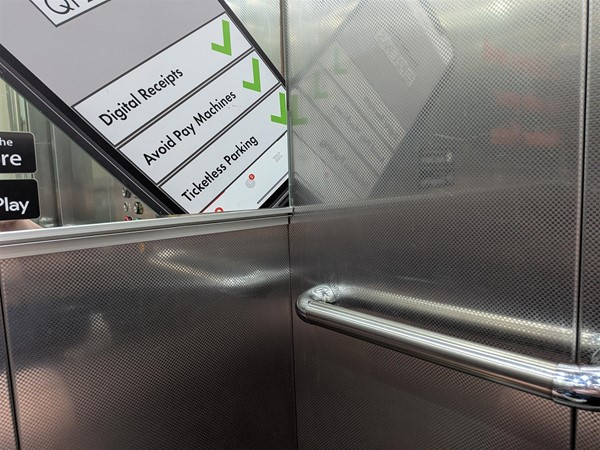 image of handrail and mirror inside the lift