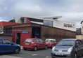 Exterior of the Museum of Free Derry. Cars are parked outside