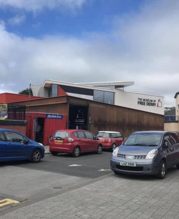 Exterior of the Museum of Free Derry. Cars are parked outside