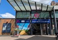 Image of entrance to Bristol Bus & Coach station, there is a Wizard of Oz themed Gromit statue outside
