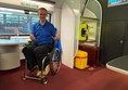 Paul on board the Eurostar and sitting in the dedicated wheelchair space.