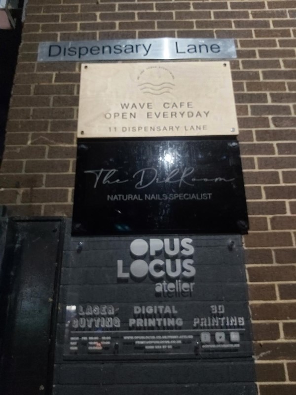 Picture of a sign for Dispensary Lane and its shops