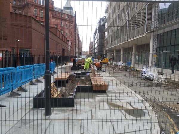 Picture of some roadworks behind a fence