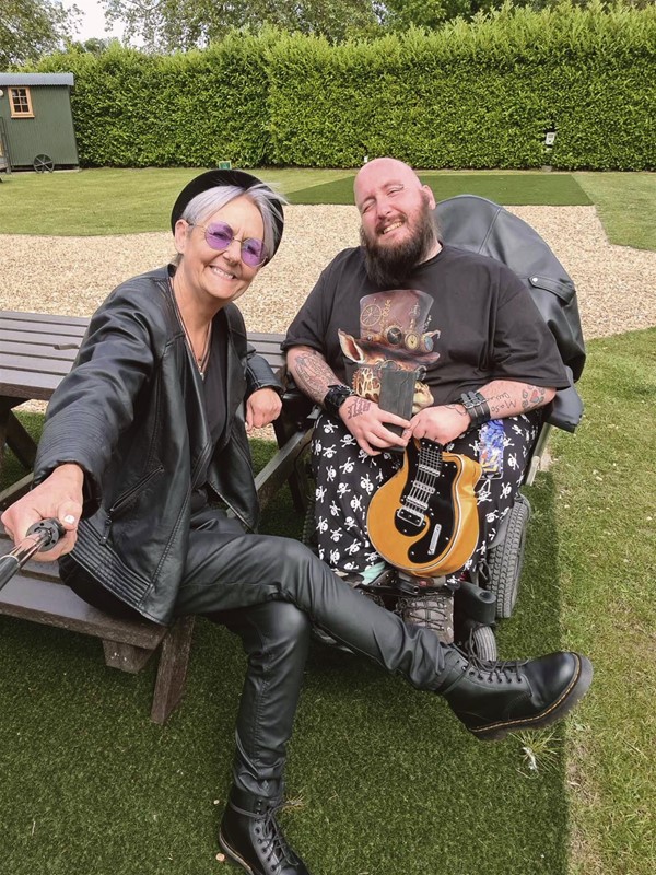 Image of a person in a wheelchair and another person