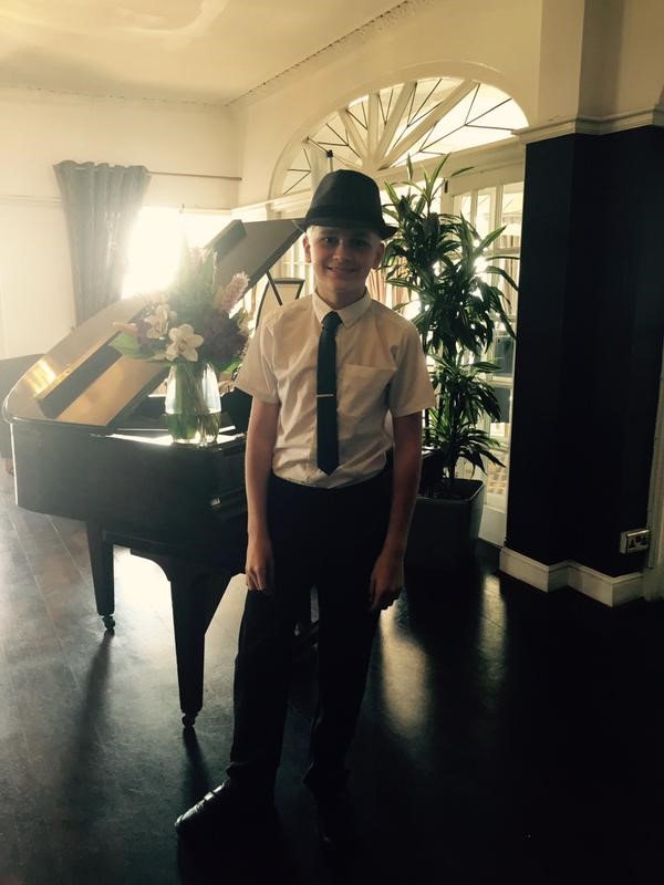 Picture of The Brighton Hotel - Child in a hat and tie standing in front of a piano