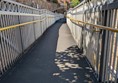 Image of step ramp down to the platforms, there are yellow rails on either side side