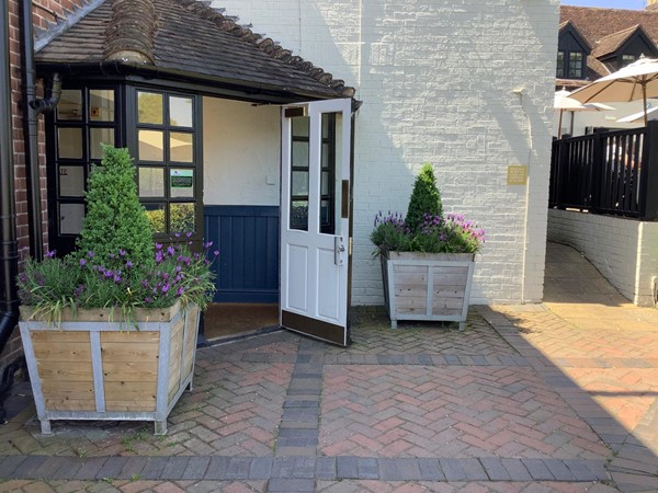There is an entrance as you approach the Inn, on the level