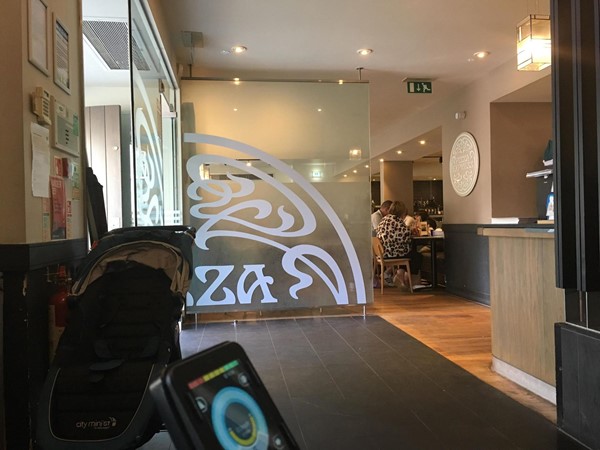 Image of the inside entrance of Pizza Express where customers wait for a table.