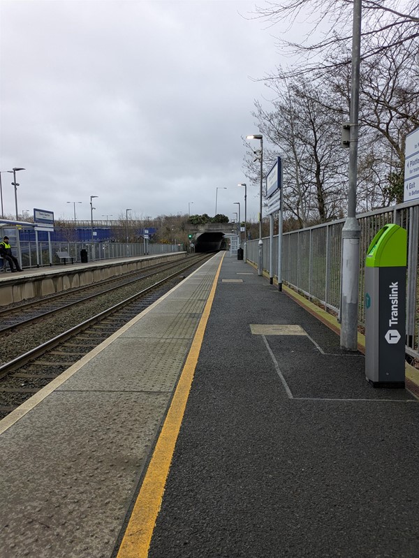 Image of the vacant platform, showing signage and tactile paving at the edge.