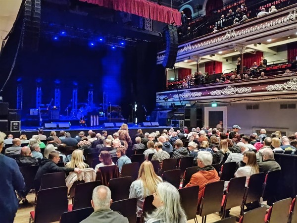 Picture of an audience facing a stage