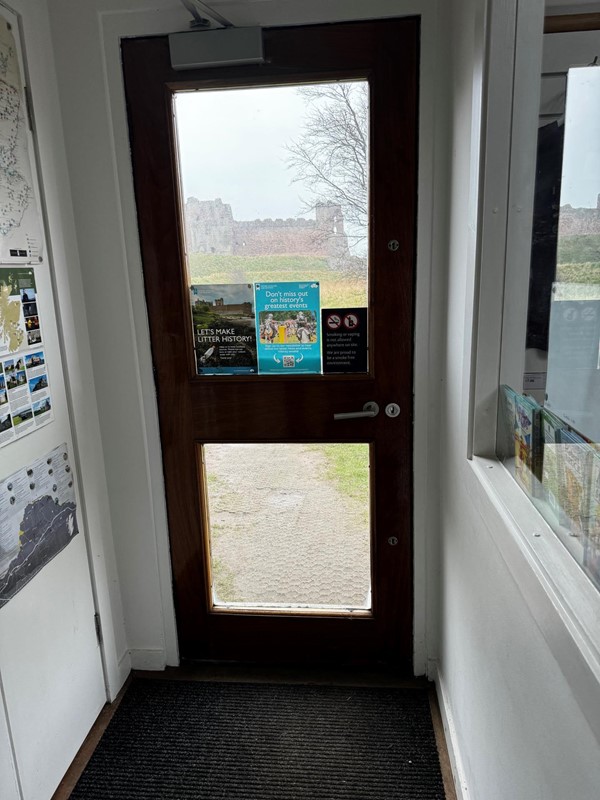 Narrow corridor from visitor reception into the castle grounds