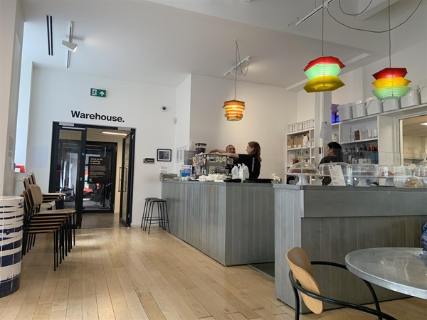 image of the café counter and door to the Warehouse exhibition space