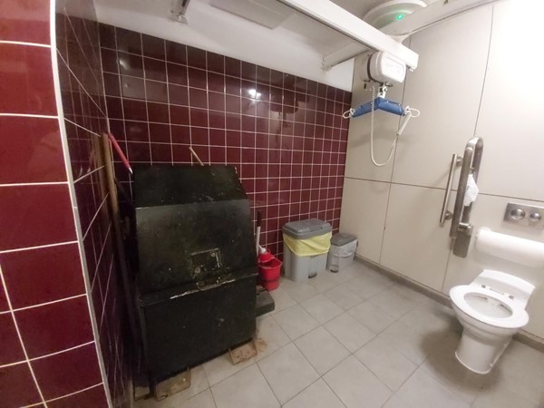 Cleaning and miscellaneous items being stored in the accessible toilet