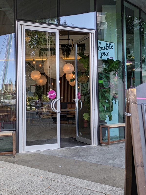 Image of door to the café, on door is pinned open