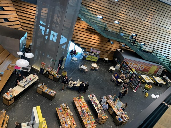 A photo taken looking over the first floor balcony and looking down to the shop area of the ground floor