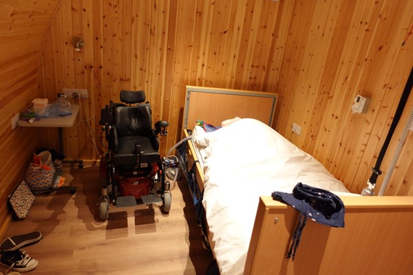 Image of how we set up the bedroom for when my powerchair is at the side of my bed.