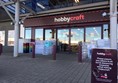Image of the entrance to the shop with the set of automatic doors.