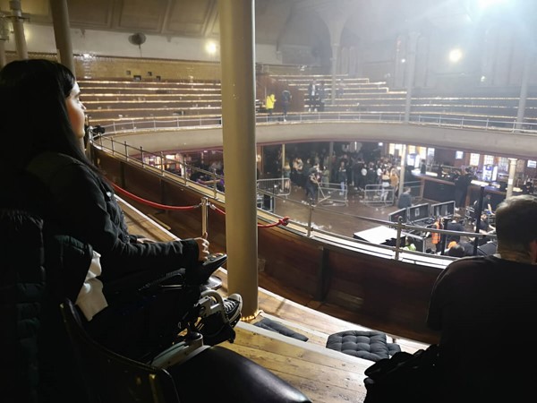Wheelchair user sitting in the accessible area.