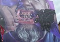 This is a MASSIVE artwork of a man's face with grills on his teeth. He looks like he is crying and he is opening his mouth with his hands to show the grills and the word ACAB on his inner bottom lip.. He has a grey beard and moustache. You can just see the collar of his purple t shirt.