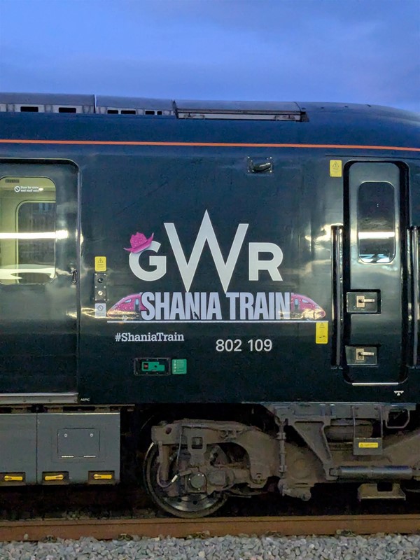 Image of a GWR branded train. The G is decorated with a pink cowboy hat and below the livery is the name 'Shania Twain'