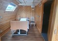 \Image of the bedroom in the accessible glamping pod including the profiling bed and tracking hoist.