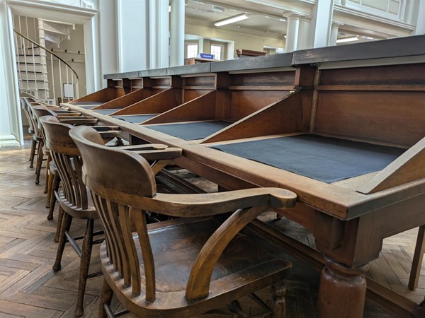 Image of study desks and wooden chairs