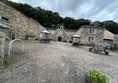 Image of picnic benches outside a stone building