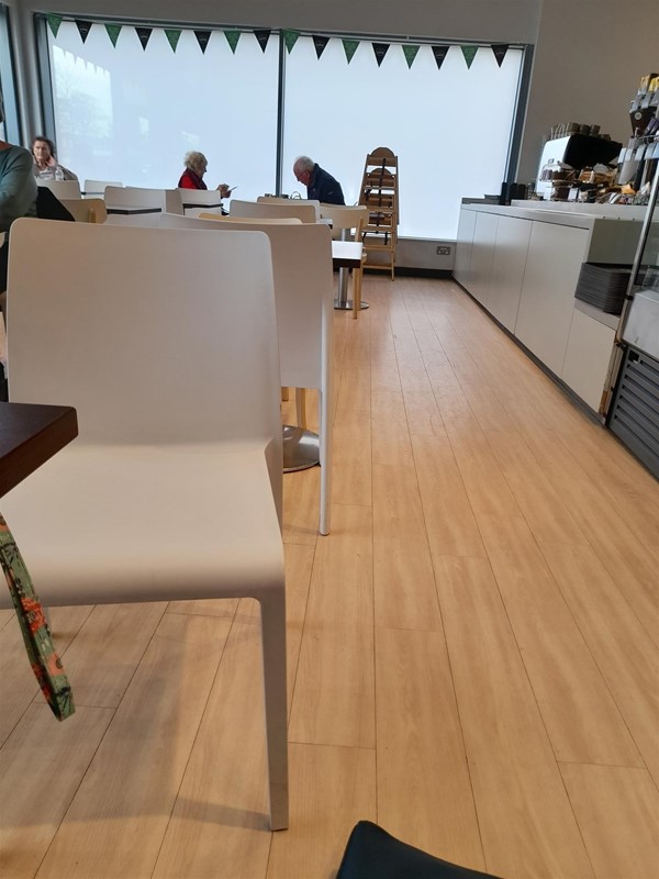 Space betwenmmjthe till and tables. When no one is there you can get past but when it is busy it is hard.