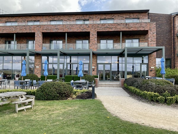 Image of a building and picnic benches