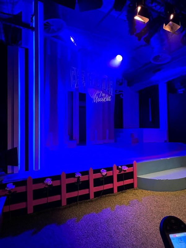 An empty stage lit in blue.