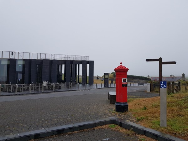 The National Trust visitor centre on the cliffs above the rocks of the Giant's Causeway. View is from the blue badge parking spaces and the building itself had very good access.