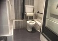 Wheelchair accessible toilet. Note limitations on transfer area and turning space.
